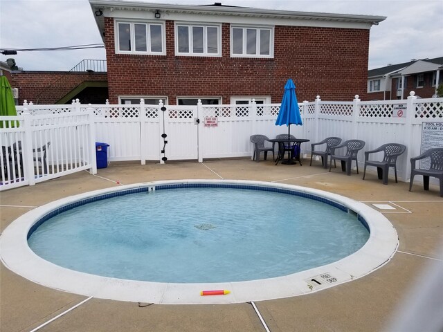 3530 Long Beach Rd Unit 68, Oceanside, NY 11572 - view of swimming pool with a fenced backyard, a fenced in pool, and a patio