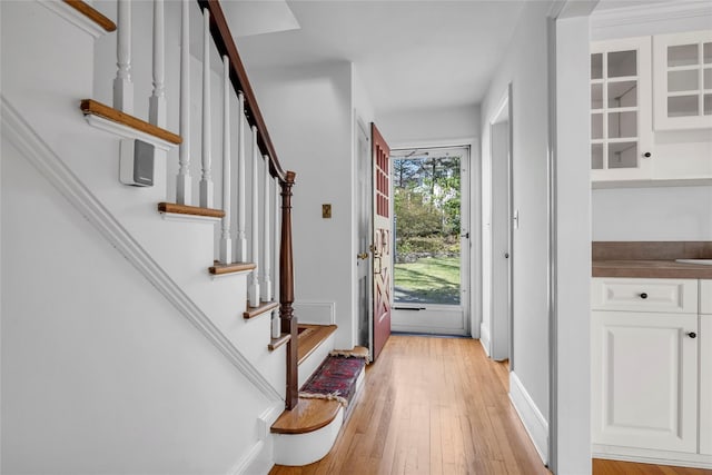 entryway with stairs and light wood finished floors