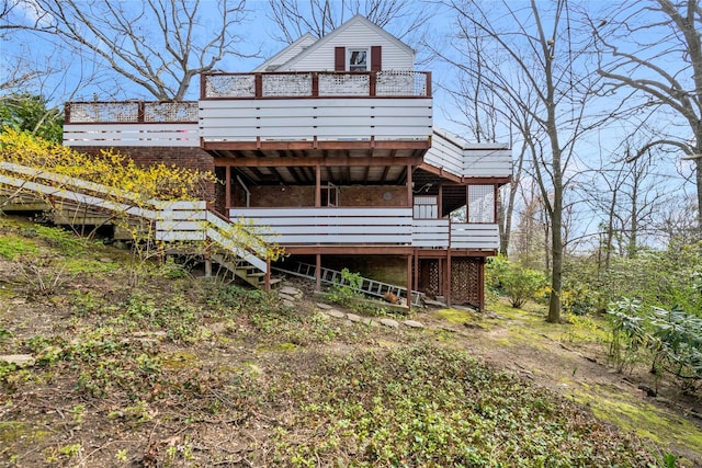 rear view of house featuring a deck