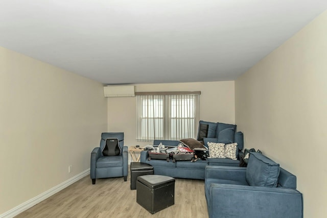 living room featuring light wood-type flooring, an AC wall unit, and baseboards