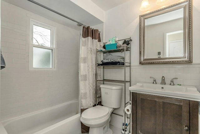 full bath featuring a wainscoted wall, toilet, tile walls, shower / bath combination with curtain, and vanity