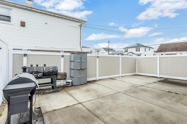 view of patio with grilling area and a fenced backyard