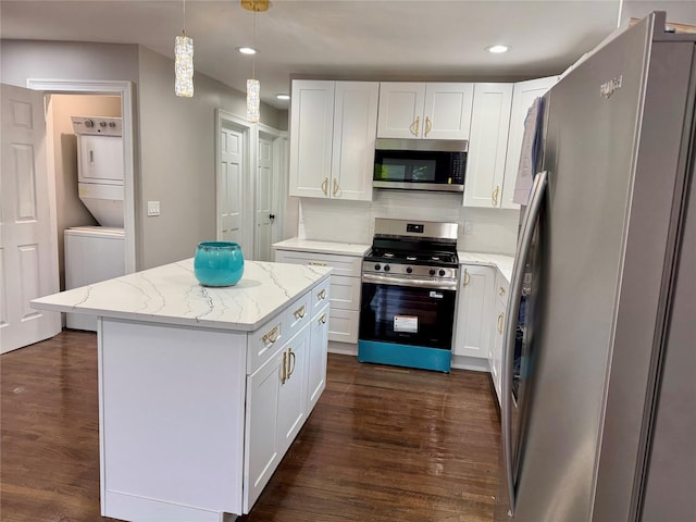 38 Moffitt Blvd, East Islip, NY 11730 - kitchen featuring stainless steel appliances, estacked washer and dryer, dark wood finished floors, white cabinets, and recessed lighting