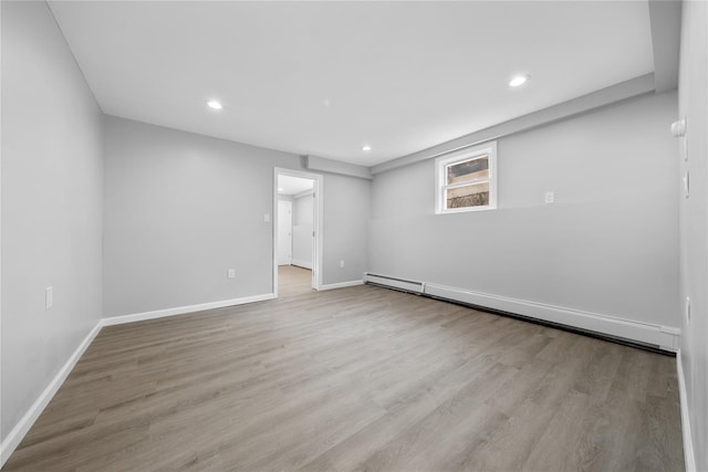 38 Moffitt Blvd, East Islip, NY 11730 - below grade area featuring baseboard heating, wood finished floors, baseboards, and recessed lighting