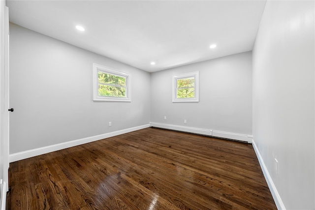 38 Moffitt Blvd, East Islip, NY 11730 - spare room featuring baseboards, dark wood finished floors, recessed lighting, and a baseboard heating unit