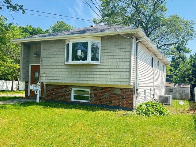 38 Moffitt Blvd, East Islip, NY 11730 - view of home's exterior featuring a lawn and a central air condition unit