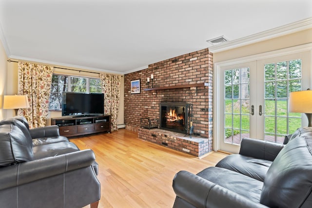 living room featuring plenty of natural light, visible vents, and crown molding