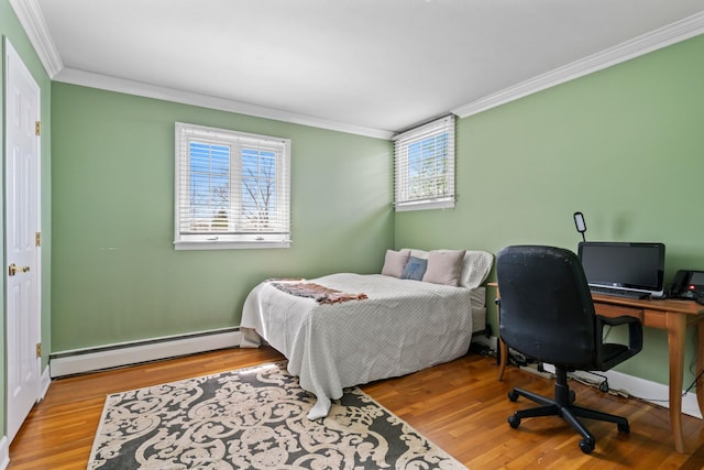 bedroom with baseboards, wood finished floors, crown molding, and baseboard heating