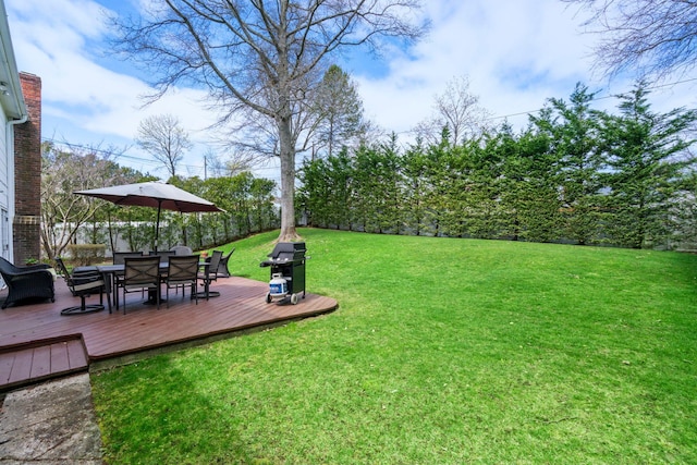 view of yard with outdoor dining area and a deck
