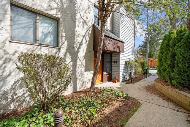 exterior space with stucco siding and fence