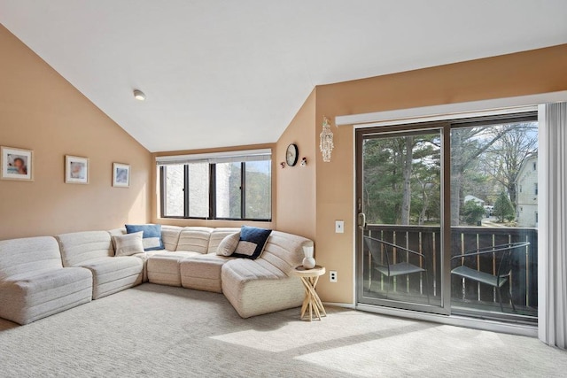 carpeted living area with lofted ceiling