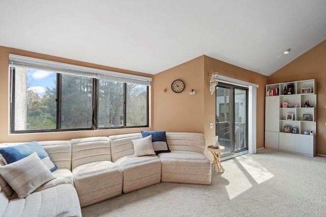 living room with lofted ceiling, carpet floors, and a healthy amount of sunlight