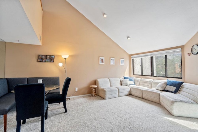 living area featuring baseboards, carpet flooring, and high vaulted ceiling