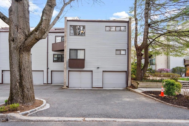 exterior space with an attached garage and aphalt driveway