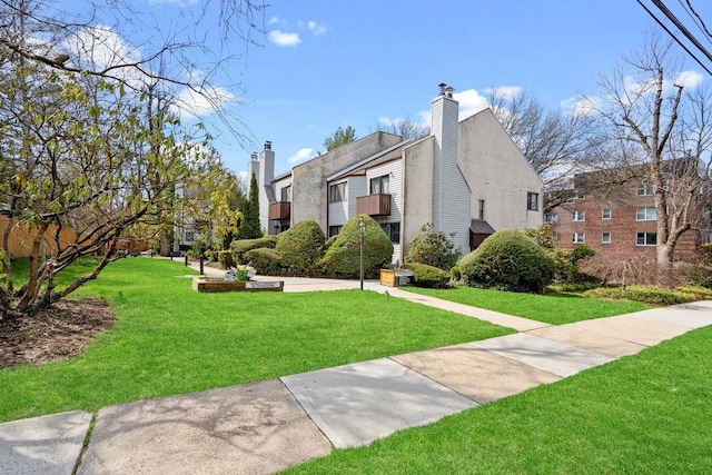 exterior space featuring a lawn and a chimney