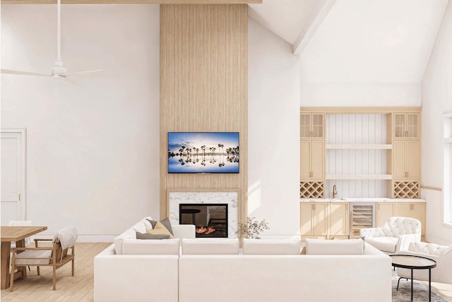 2215 Laurel Ave, Southold, NY 11971 - living area featuring wine cooler, lofted ceiling, light wood-style flooring, a high end fireplace, and baseboards