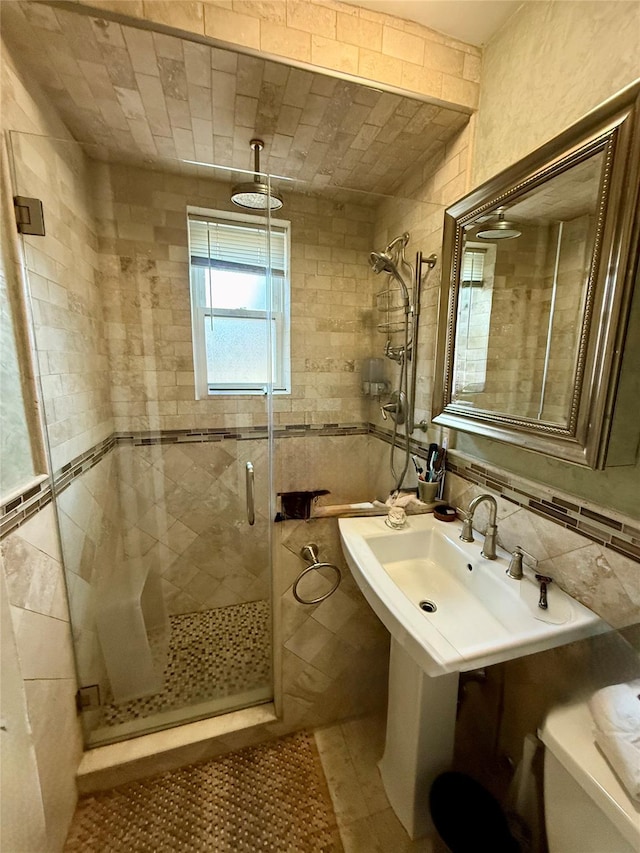 2 Lockwood Ave Unit 2B, Bronxville, NY 10708 - full bathroom featuring a stall shower, tile walls, and toilet