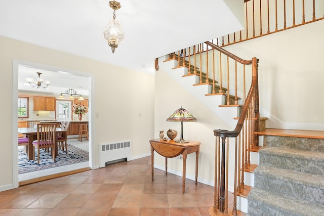 1449 Riverview Ave, Peekskill, NY 10566 - stairway with radiator heating unit, a chandelier, and baseboards