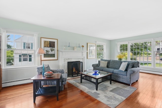 1449 Riverview Ave, Peekskill, NY 10566 - living area featuring hardwood / wood-style flooring, a baseboard heating unit, and a premium fireplace
