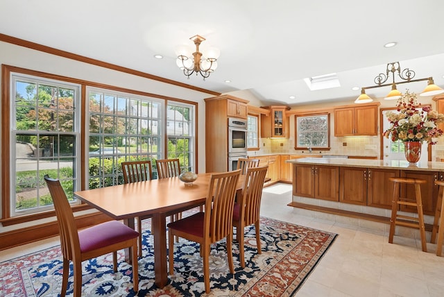 1449 Riverview Ave, Peekskill, NY 10566 - dining area featuring a skylight, a chandelier, crown molding, light tile patterned floors, and recessed lighting