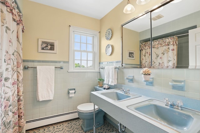 1449 Riverview Ave, Peekskill, NY 10566 - bathroom with a baseboard heating unit, tile walls, toilet, curtained shower, and wainscoting