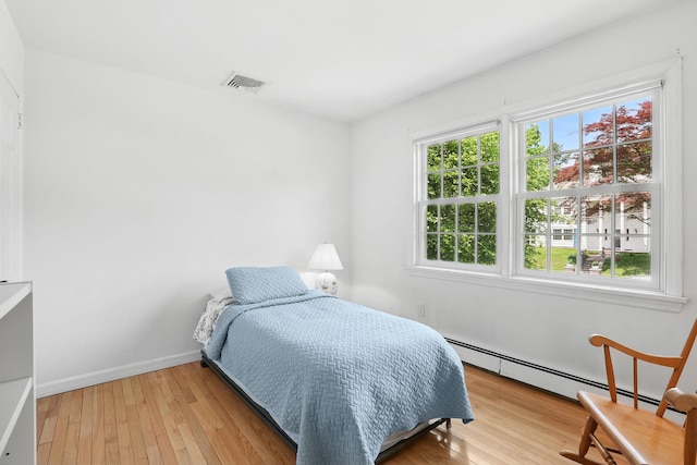 1449 Riverview Ave, Peekskill, NY 10566 - bedroom featuring baseboard heating, light wood-style floors, and baseboards