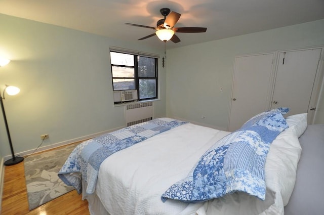 66 Rockledge Rd Unit 1B, Hartsdale, NY 10530 - bedroom featuring radiator heating unit, wood finished floors, cooling unit, ceiling fan, and baseboards