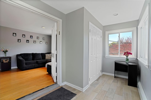 interior space with baseboards, light wood-type flooring, and recessed lighting