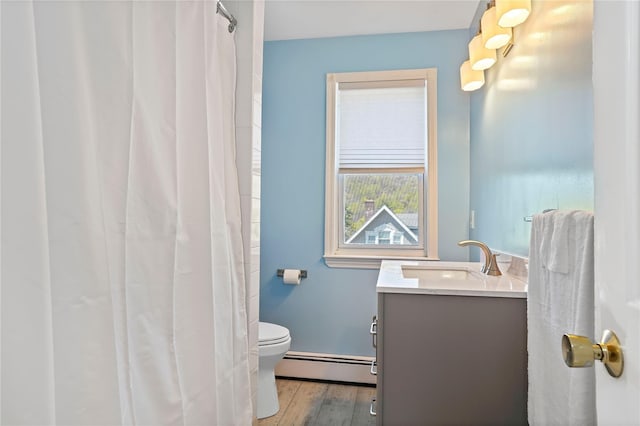 bathroom with wood finished floors, a baseboard radiator, a shower with curtain, toilet, and vanity