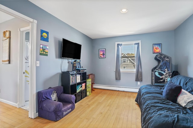 living room with recessed lighting, baseboards, a baseboard heating unit, and wood-type flooring