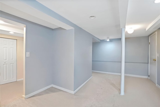 finished below grade area featuring baseboards and carpet