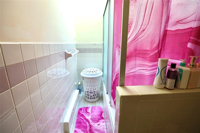 bathroom featuring tile walls and wainscoting