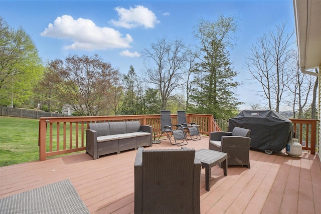 deck with a lawn, fence, outdoor lounge area, and grilling area