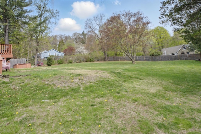 view of yard featuring fence and a wooden deck