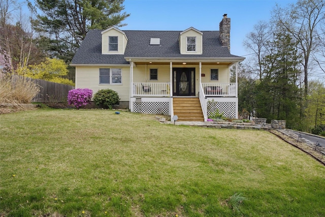 cape cod-style house featuring fence, stairs, a front yard, a chimney, and covered porch