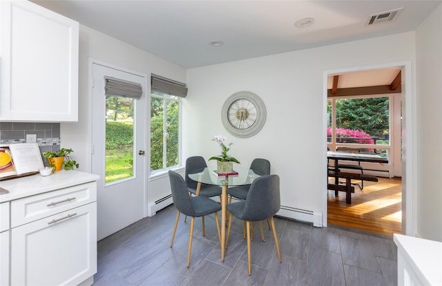 dining area with baseboard heating, dark wood-style flooring, and recessed lighting