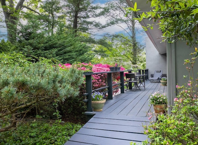wooden terrace featuring outdoor dining space