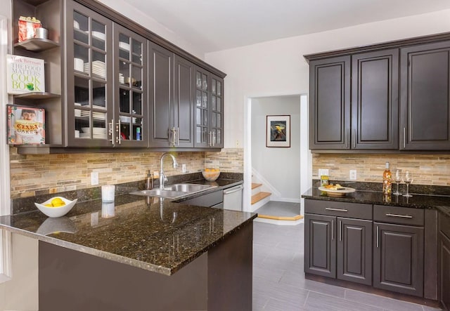 bar with a sink, backsplash, stairs, and dishwasher