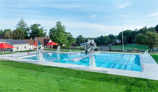 community pool featuring a water slide