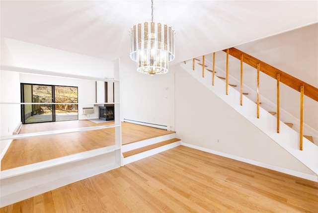 52 Round Hill Rd, Dobbs Ferry, NY 10522 - interior space featuring a fireplace, baseboard heating, wood finished floors, a notable chandelier, and stairs