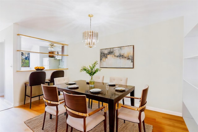 52 Round Hill Rd, Dobbs Ferry, NY 10522 - dining area with baseboards, an inviting chandelier, and light wood-style floors