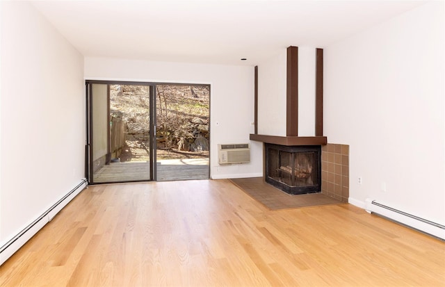 52 Round Hill Rd, Dobbs Ferry, NY 10522 - unfurnished living room with a multi sided fireplace, baseboards, a baseboard heating unit, and wood finished floors