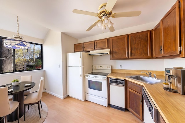 52 Round Hill Rd, Dobbs Ferry, NY 10522 - kitchen with white appliances, light wood-style floors, under cabinet range hood, a sink, and vaulted ceiling
