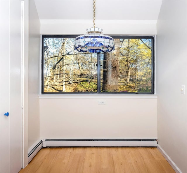 52 Round Hill Rd, Dobbs Ferry, NY 10522 - unfurnished dining area featuring a healthy amount of sunlight, a baseboard radiator, and light wood-style flooring