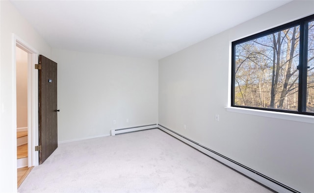52 Round Hill Rd, Dobbs Ferry, NY 10522 - empty room featuring light colored carpet, baseboard heating, and a wealth of natural light