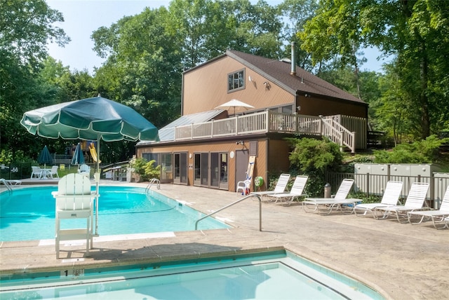52 Round Hill Rd, Dobbs Ferry, NY 10522 - back of property featuring fence, a deck, a community pool, french doors, and a patio area