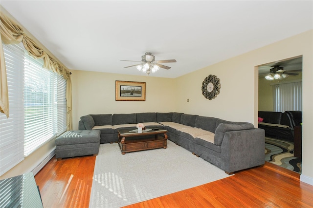 16 Alberta Ave, Staten Island, NY 10314 - living room with a ceiling fan, wood finished floors, and baseboard heating