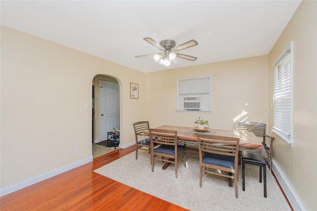 16 Alberta Ave, Staten Island, NY 10314 - dining room with arched walkways, cooling unit, baseboards, wood finished floors, and ceiling fan