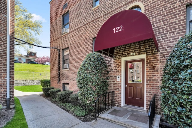 doorway to property with brick siding