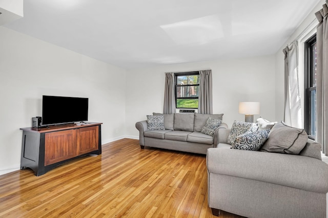 living room featuring light wood-style floors and baseboards